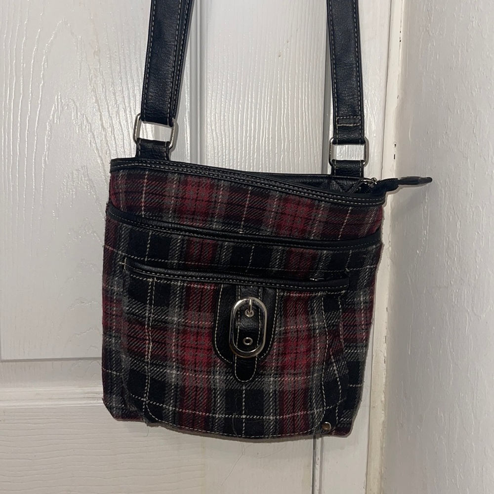 Plaid black n Red Cross over bag with adjustable straps it has 3 main pockets